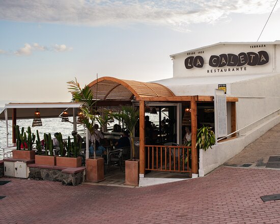 Restaurant, Terrace Bar, Cafe on the seafront in the early morning at La Caleta, Costa Adeje, Tenerife, Canary Islands, Spain